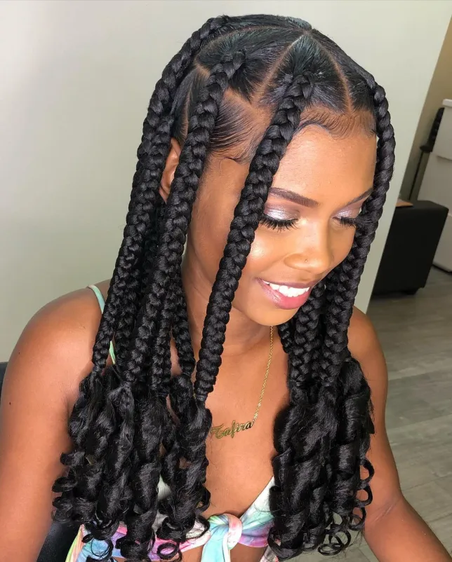 medium knotless braids with curls at the end